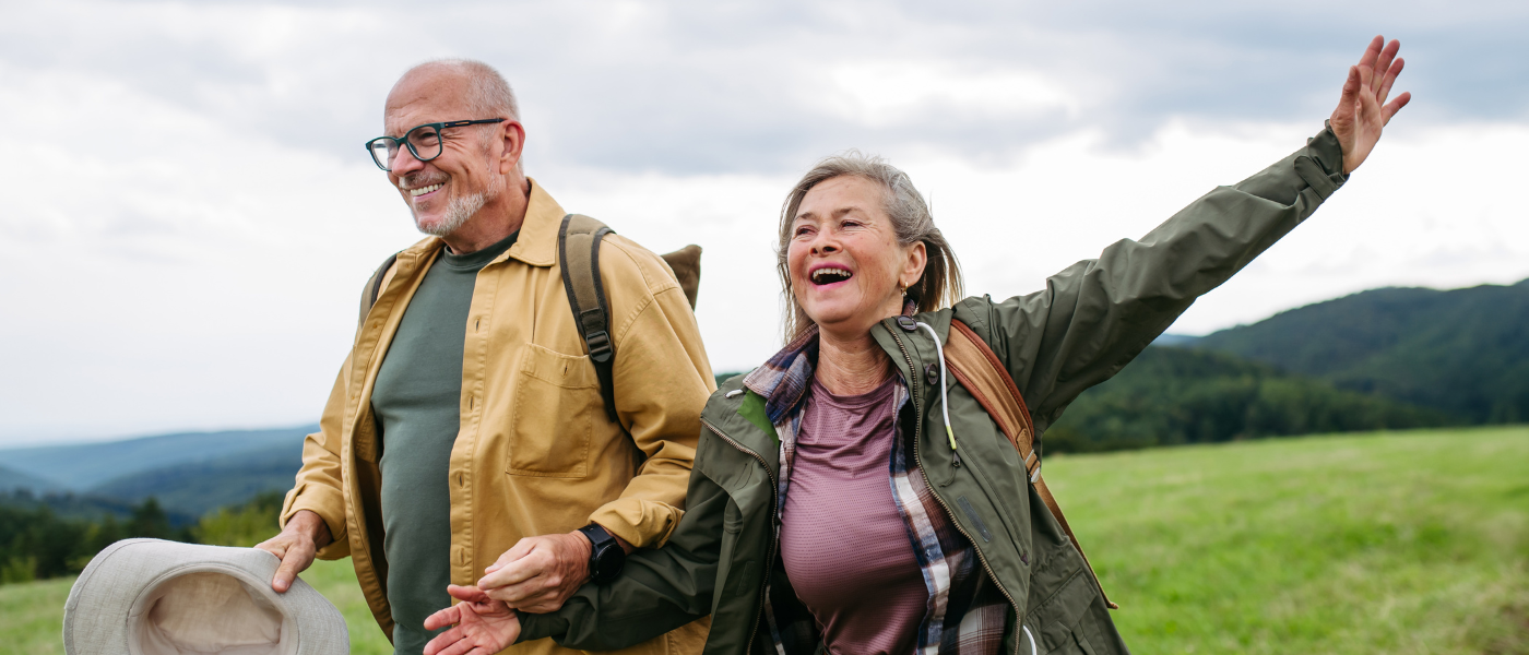 Pareja practicando senderismo y escalada ligera en montaña, representando la importancia del seguro de deportes y aventuras de Iris Global.
